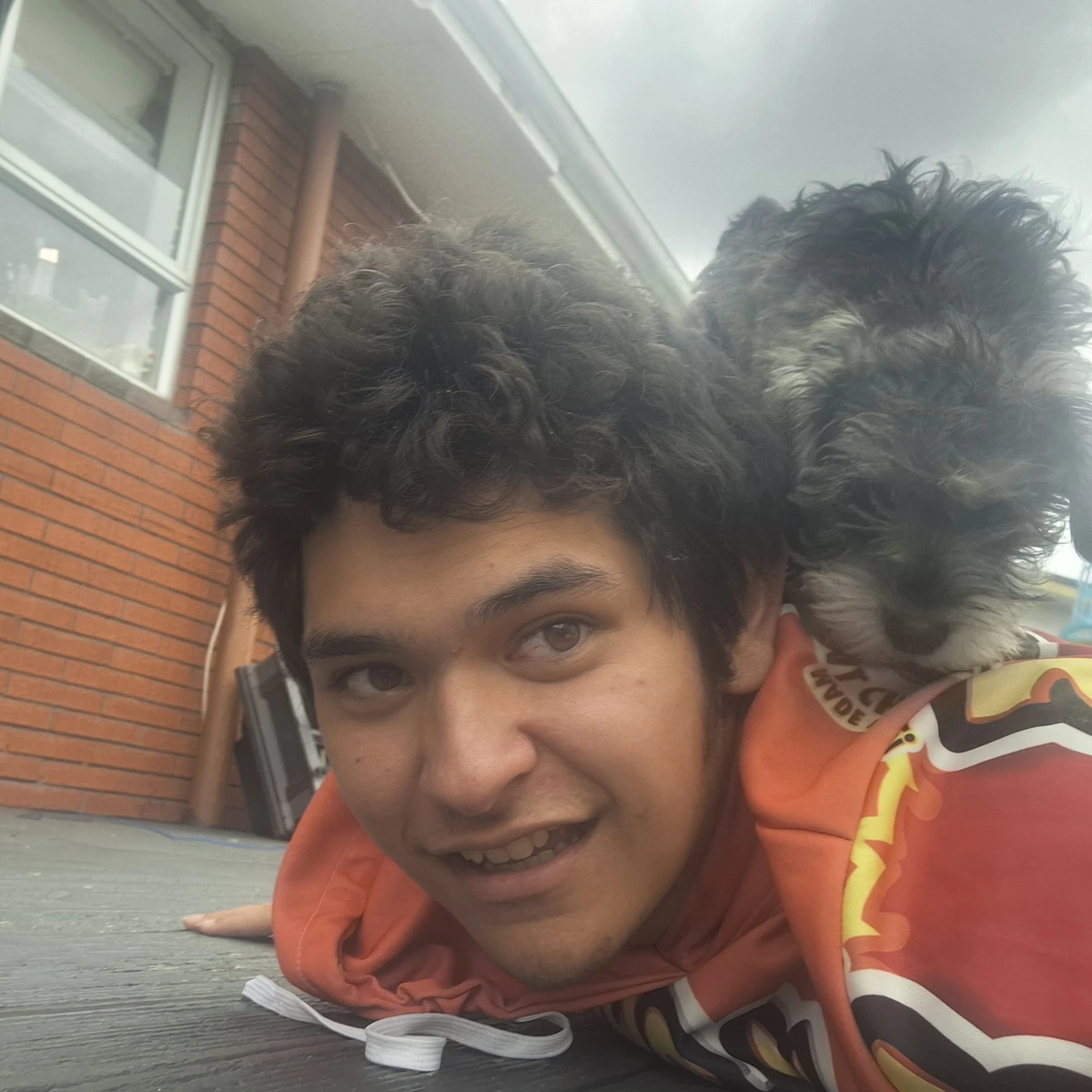 A member of the Barking Mad family relaxing with a dog